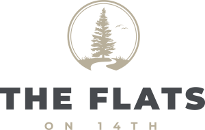 A logo with a tree and the words "THE FLATS" on a green background.